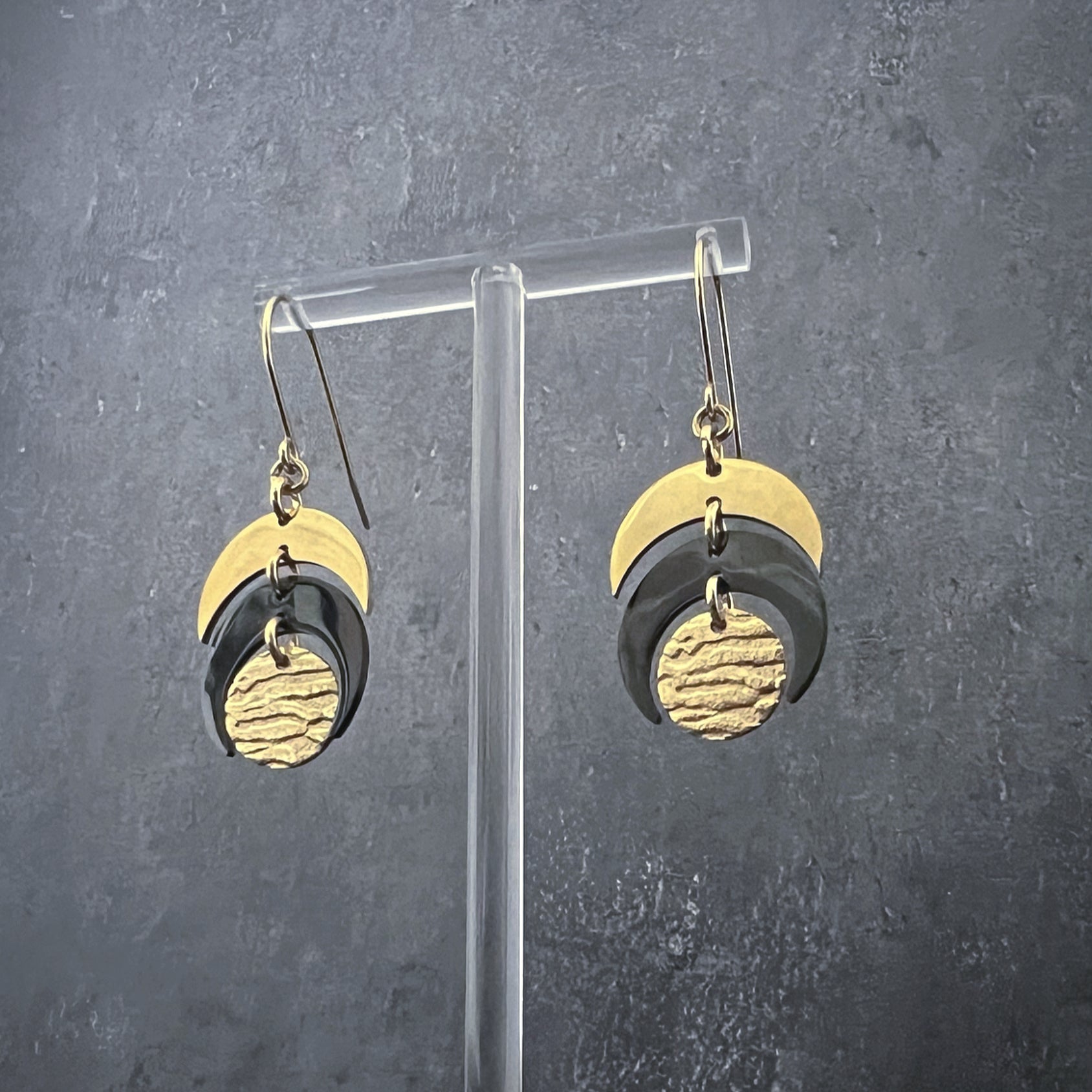 Gold and black stainless steel earrings with crescent and textured disc design inspired by lunar phases, lightweight and hypoallergenic — Lawless Jewellery.