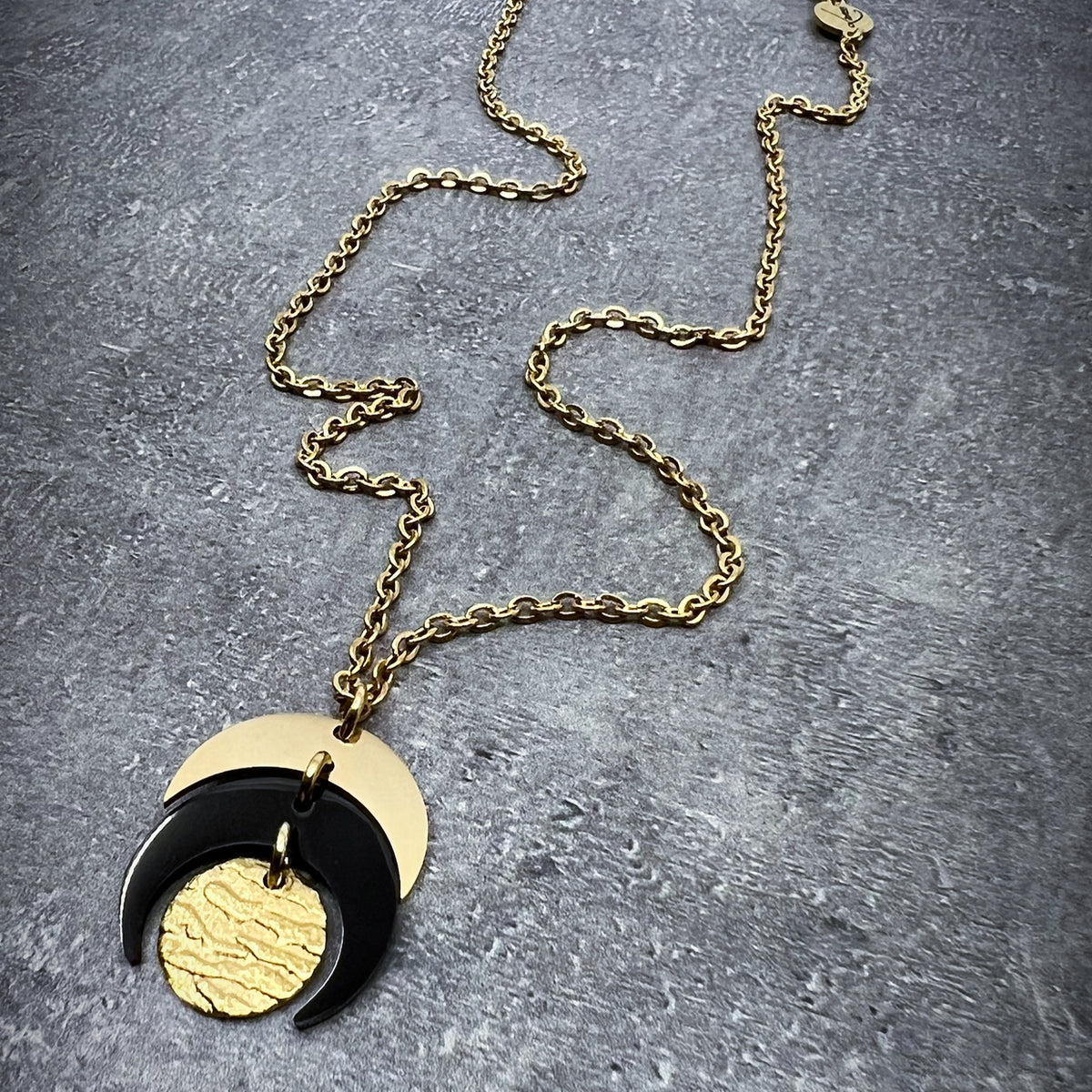 Gold and black stainless steel Luna Phase Mini Necklace with sculptural crescent pendant and adjustable chain — Lawless Jewellery.