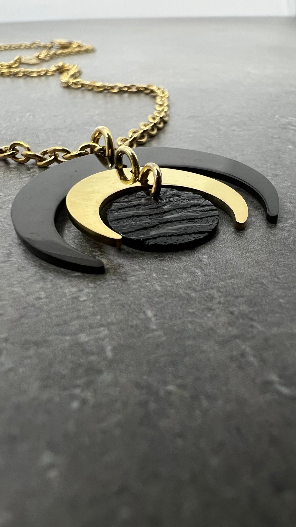 The Luna Phase Pendant Necklace — gold and black stainless steel necklace crafted in Ireland’s Dark Sky Reserve. For those who wear balance like a secret.