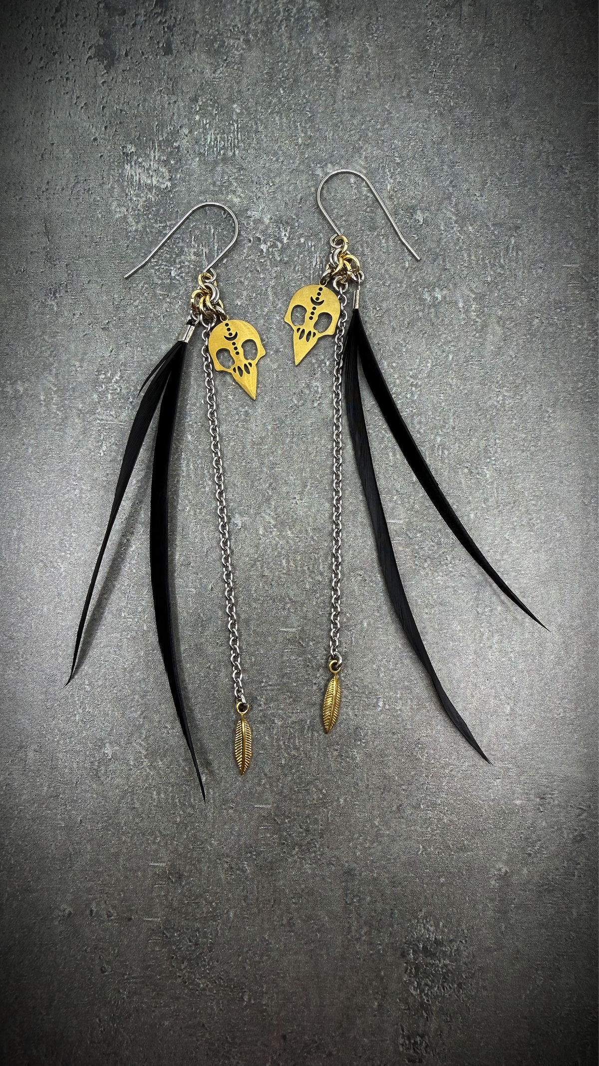 Black, silver, and gold stainless steel earrings with real feather detailing and chain accents — lightweight statement design — Lawless Jewellery