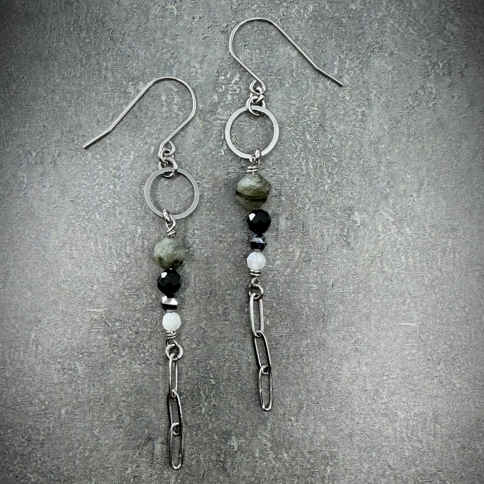 Mixed gemstone drop earrings featuring Labradorite, Black Spinel, Moonstone, and Terahertz set in stainless steel, in black, grey, white, and silver tones — Lawless Jewellery.