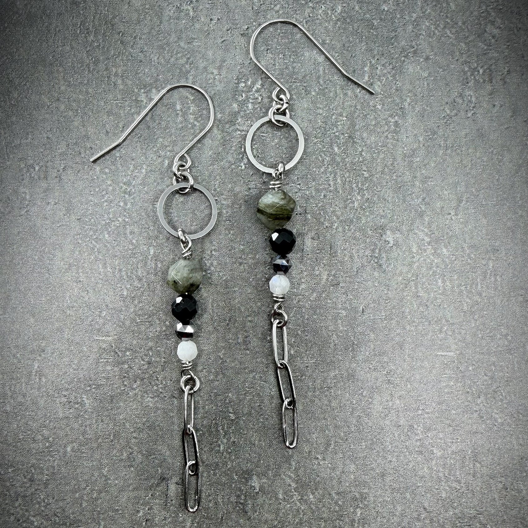 Mixed gemstone drop earrings featuring Labradorite, Black Spinel, Moonstone, and Terahertz set in stainless steel, in black, grey, white, and silver tones — Lawless Jewellery.
