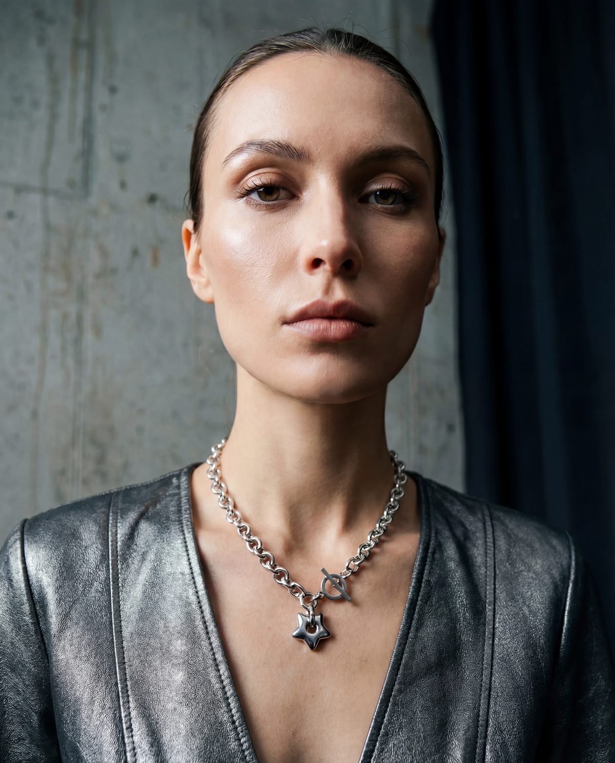 Silver stainless steel chain necklace with gold star pendant and toggle clasp, Urania Axis Necklace by Lawless Jewellery on black background