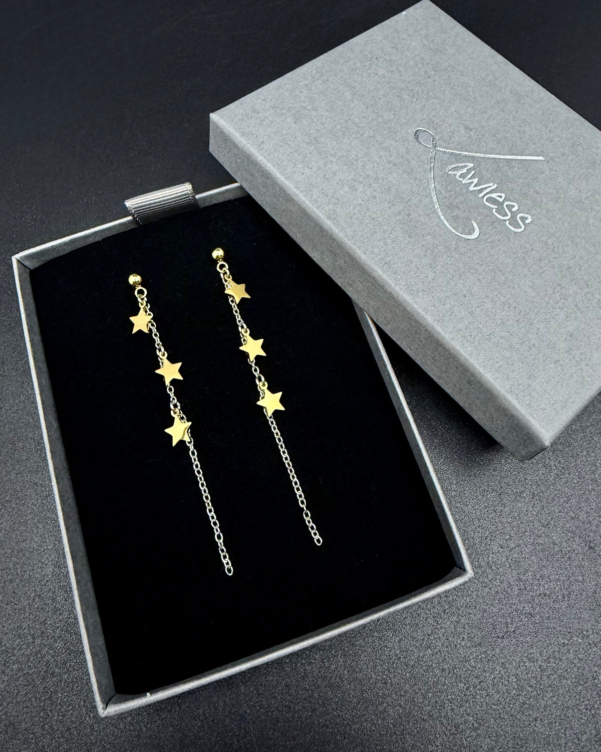 Short silver and gold star drop earrings with fine stainless steel chain, Urania Meridian Earrings 7 cm by Lawless Jewellery.