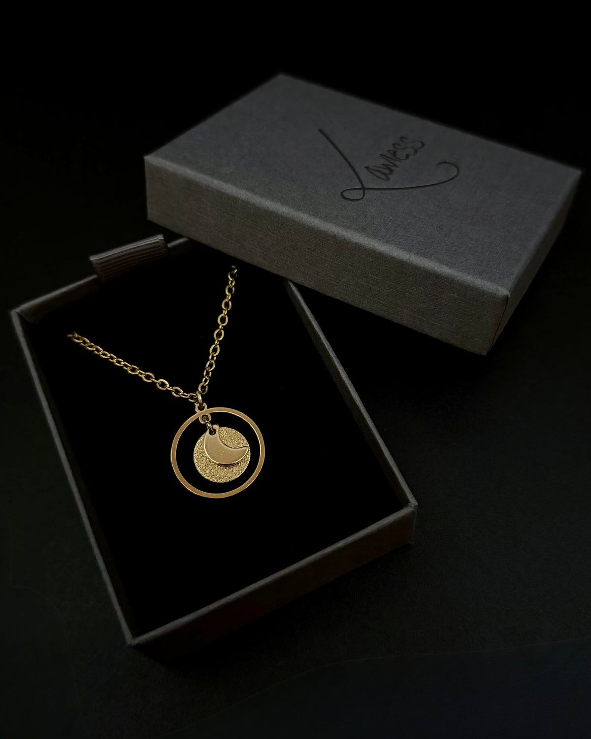 All gold reversible necklace with detachable moon and star charms, celestial pendant design in gold stainless steel, Urania Shapeshifter Necklace by Lawless Jewellery.