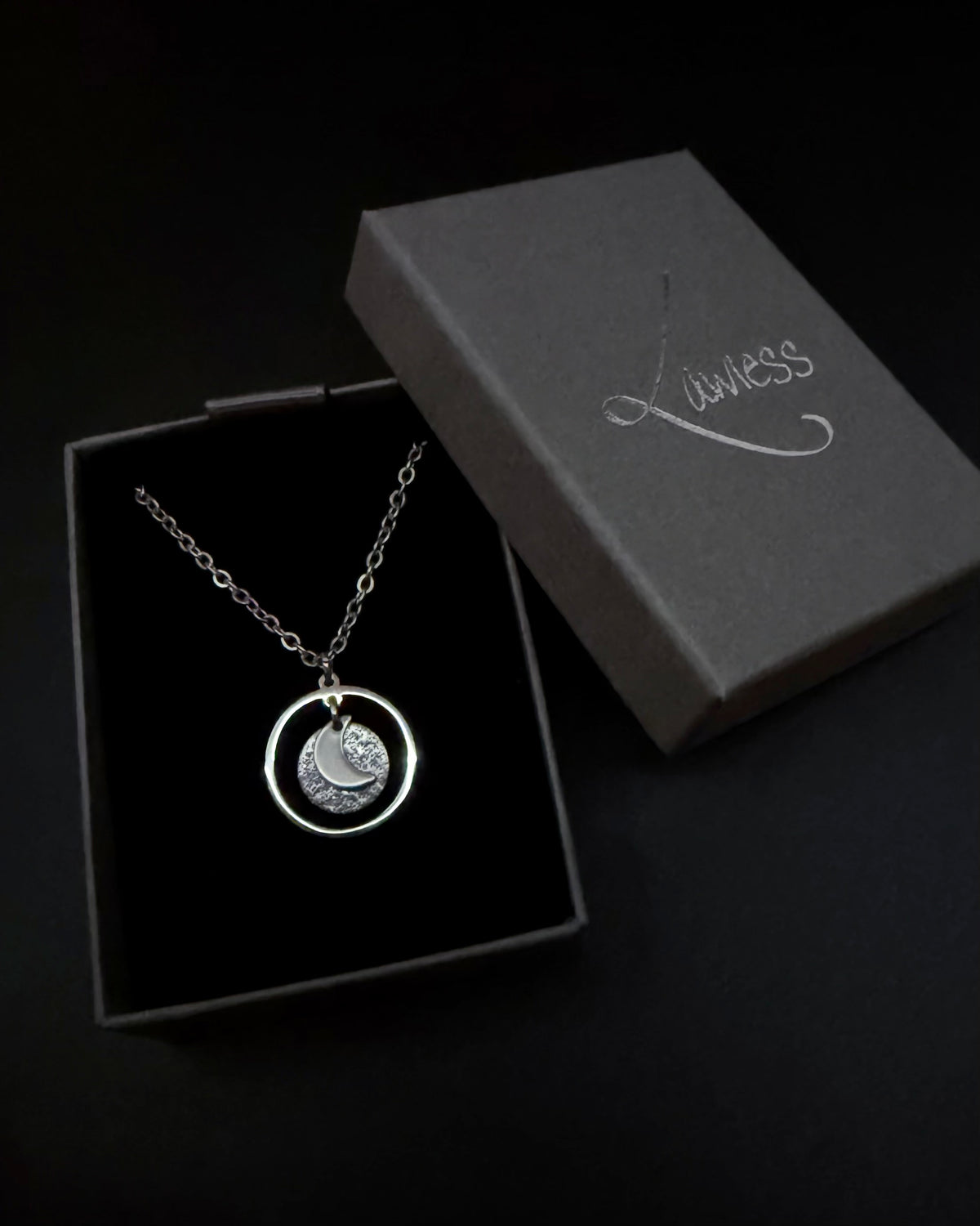 Silver reversible moon and star necklace with textured disc pendant and adjustable chain, Urania Collection by Lawless Jewellery.
