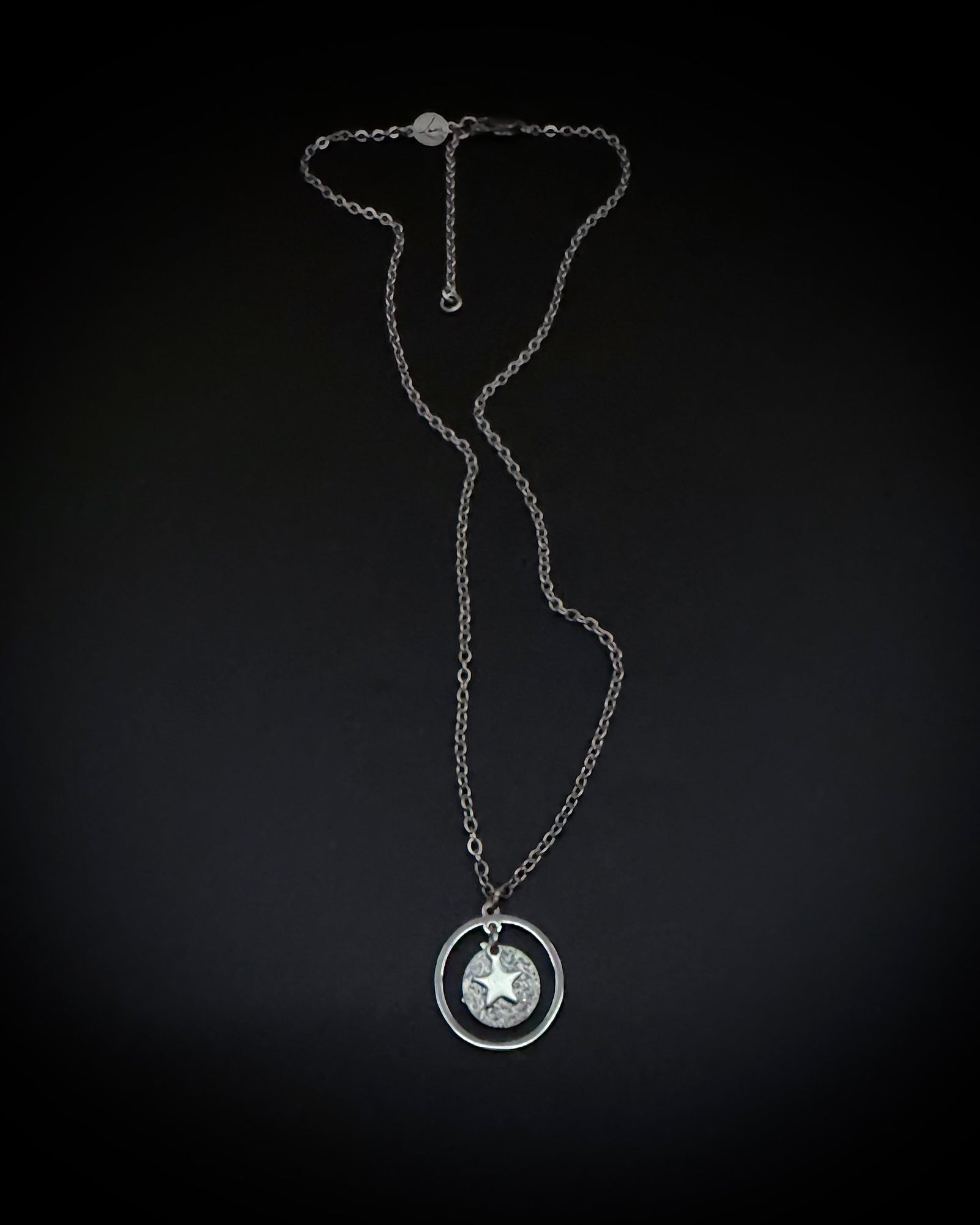 Silver reversible moon and star necklace with textured disc pendant and adjustable chain, Urania Collection by Lawless Jewellery.