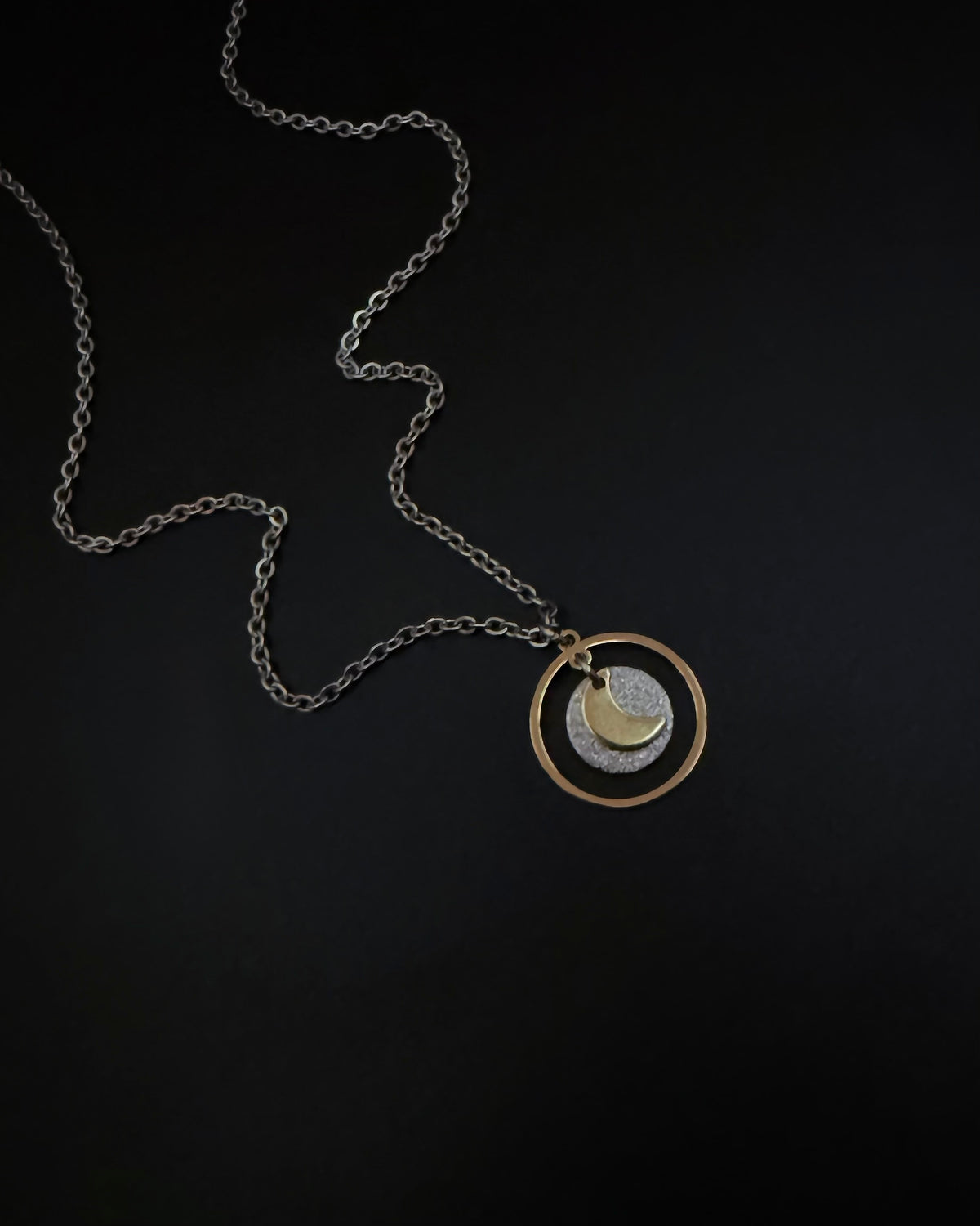 Reversible silver and gold necklace with detachable moon and star charms, mixed metal celestial pendant on chain, Urania Shapeshifter Necklace by Lawless Jewellery.