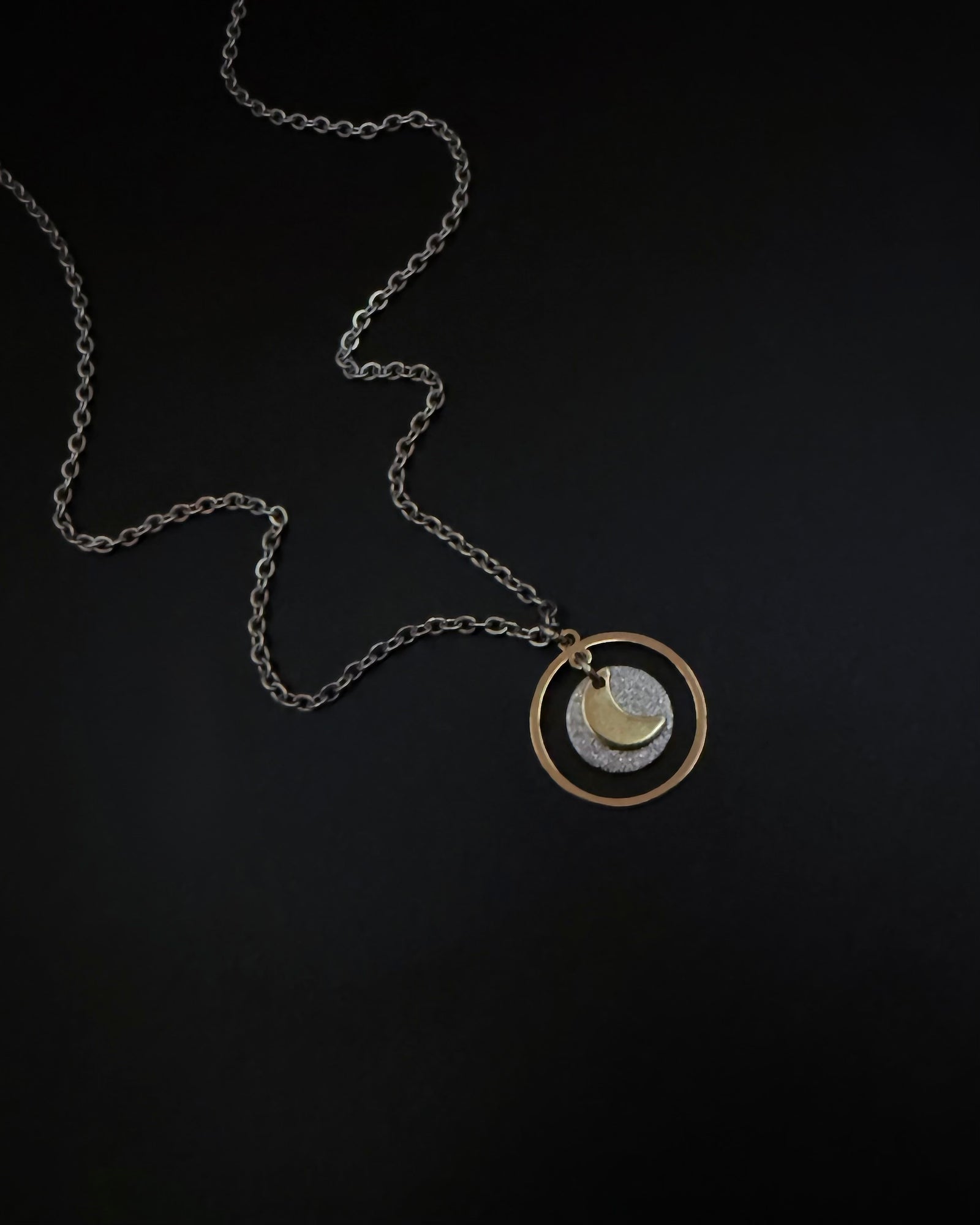 Reversible silver and gold necklace with detachable moon and star charms, mixed metal celestial pendant on chain, Urania Shapeshifter Necklace by Lawless Jewellery.