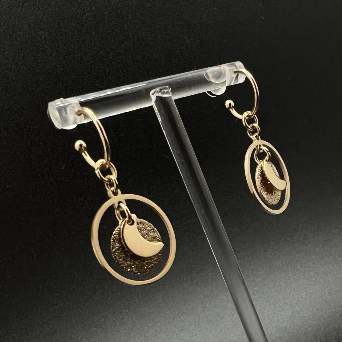 Gold stainless steel hoop earrings with detachable moon and star charms and a textured disc inside a 20 mm ring, 4 cm drop — Lawless Jewellery.
