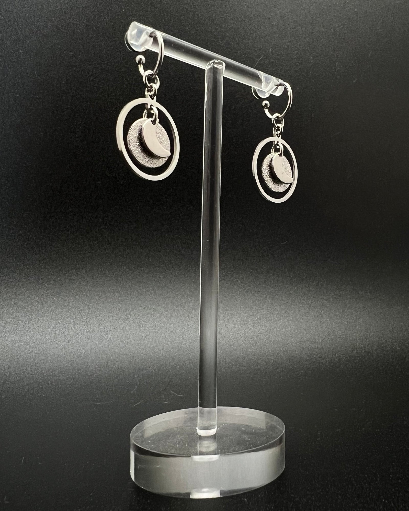 Silver stainless steel hoop earrings with detachable moon and star charms and a textured disc inside a 20 mm ring, 4 cm drop — Lawless Jewellery