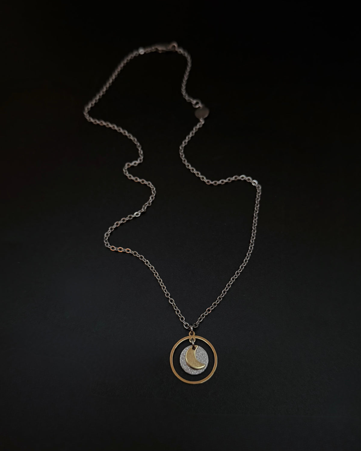 Reversible silver and gold necklace with detachable moon and star charms, mixed metal celestial pendant on chain, Urania Shapeshifter Necklace by Lawless Jewellery.