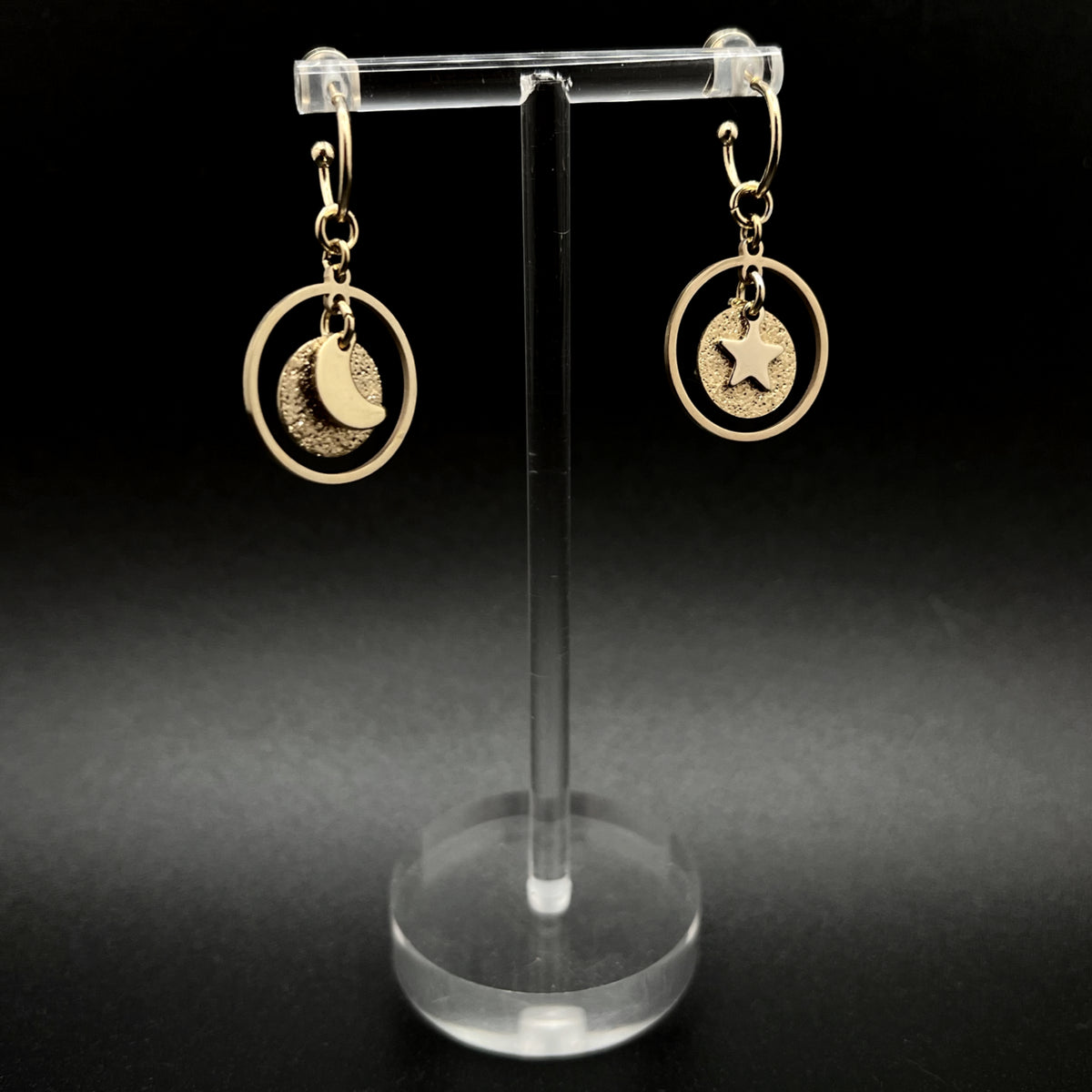 Gold stainless steel hoop earrings with detachable moon and star charms and a textured disc inside a 20 mm ring, 4 cm drop — Lawless Jewellery.