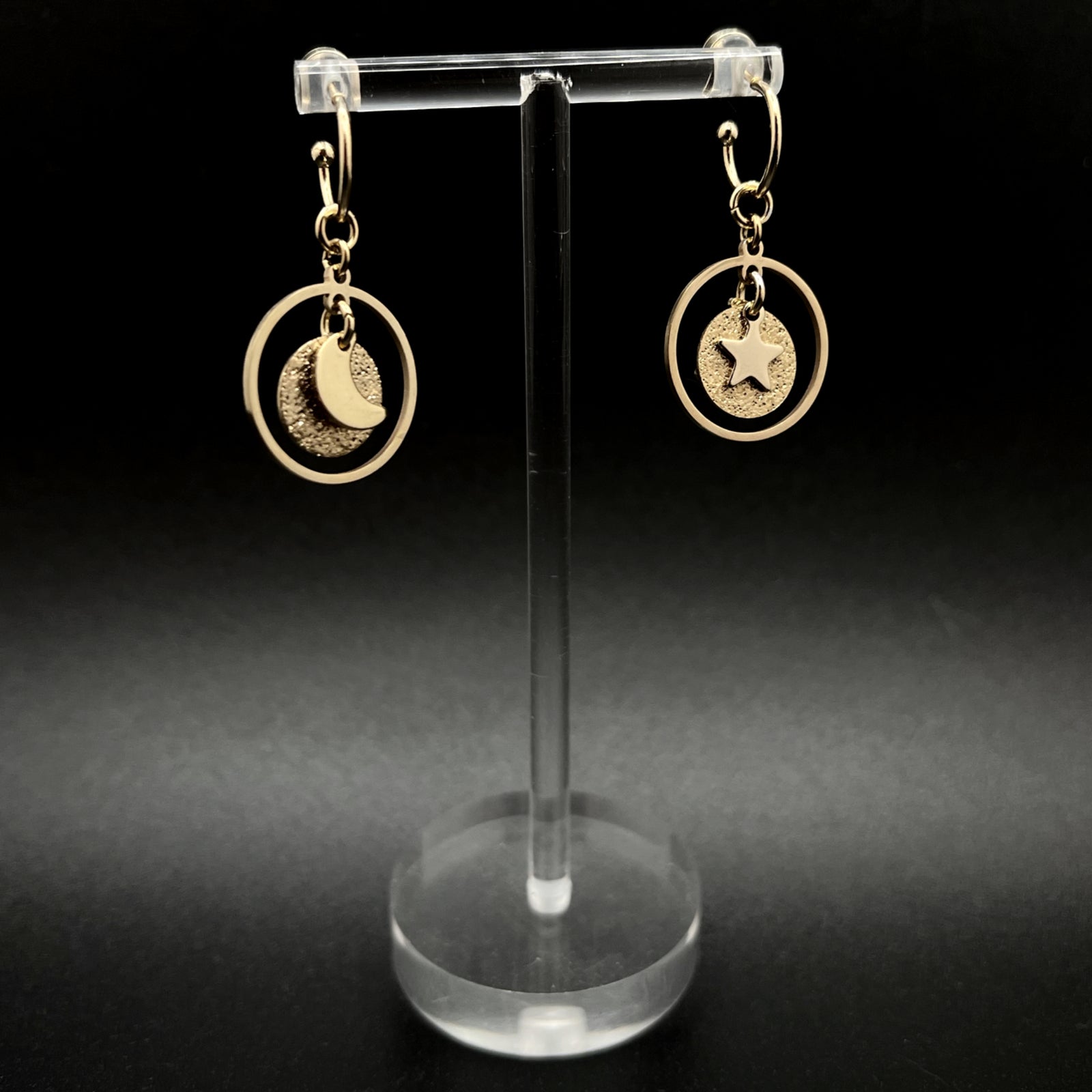 Gold stainless steel hoop earrings with detachable moon and star charms and a textured disc inside a 20 mm ring, 4 cm drop — Lawless Jewellery.