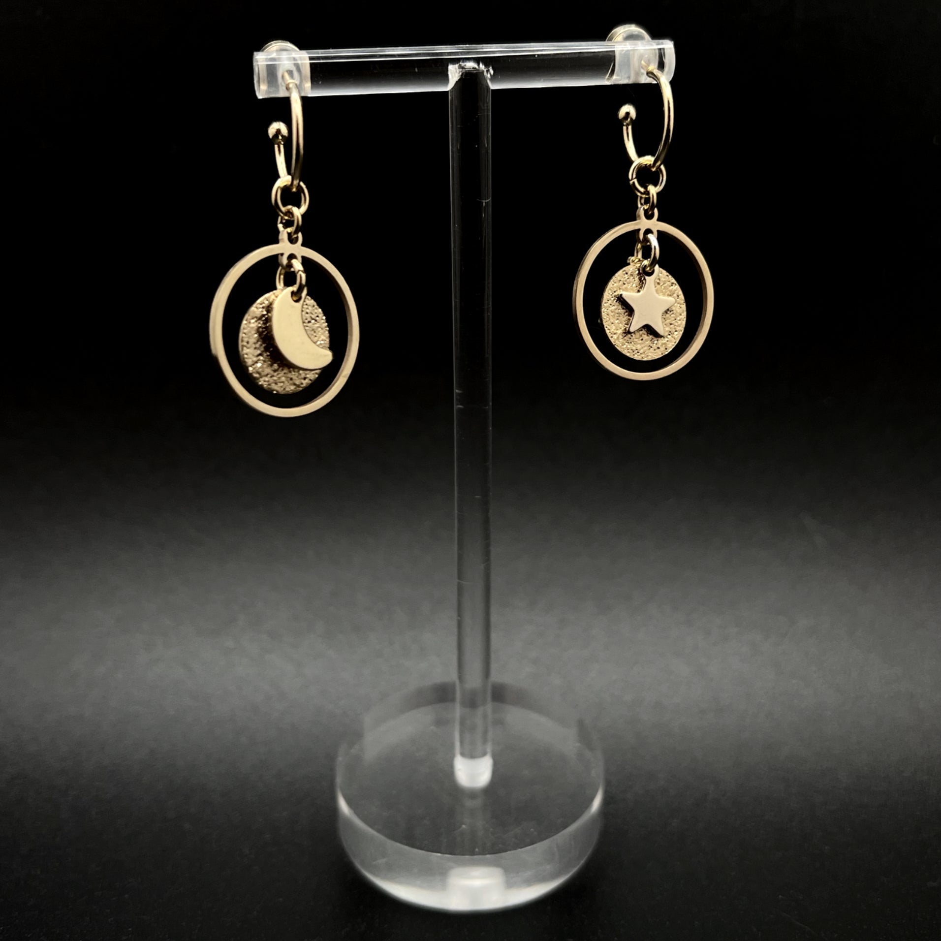 Gold stainless steel hoop earrings with detachable moon and star charms and a textured disc inside a 20 mm ring, 4 cm drop — Lawless Jewellery.