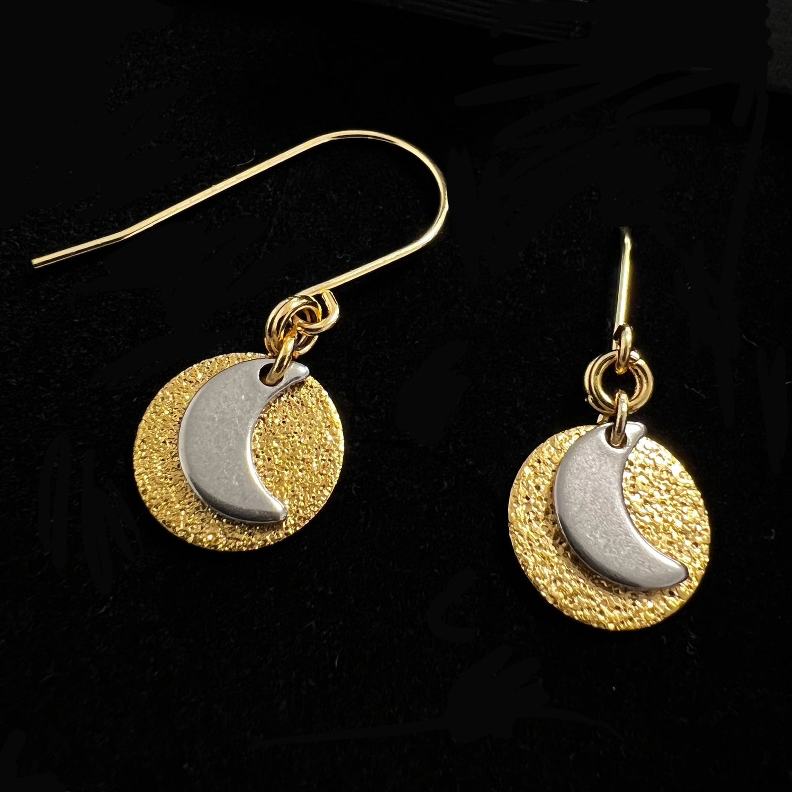 Gold and silver moon earrings with textured disc, small celestial drop earrings in stainless steel by Lawless Jewellery