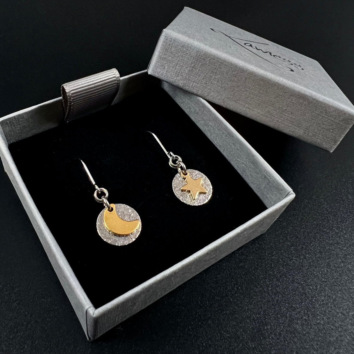 Silver and gold moon and star earrings with textured silver discs, minimalist celestial drop earrings by Lawless Jewellery