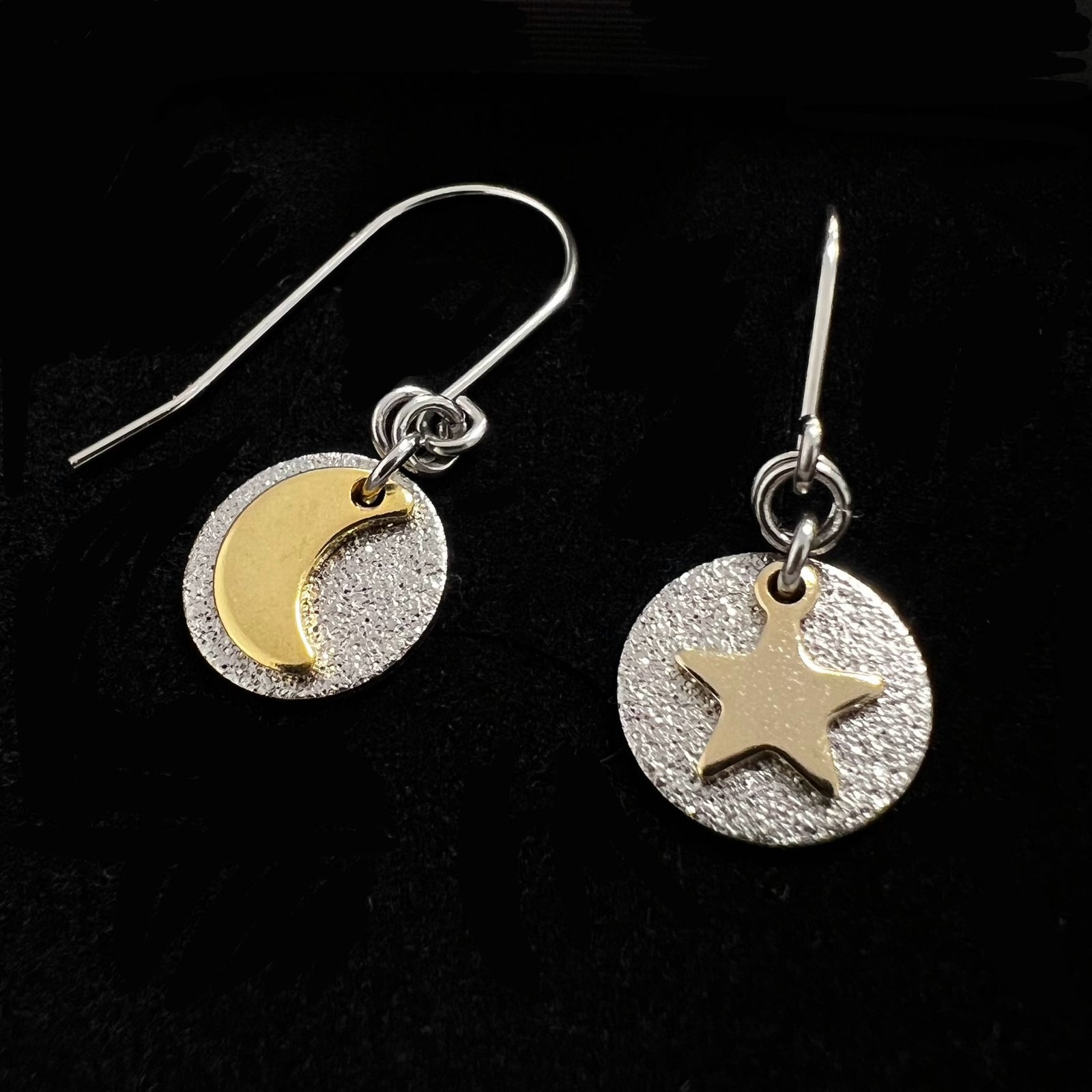 Silver and gold moon and star earrings with textured silver discs, minimalist celestial drop earrings by Lawless Jewellery