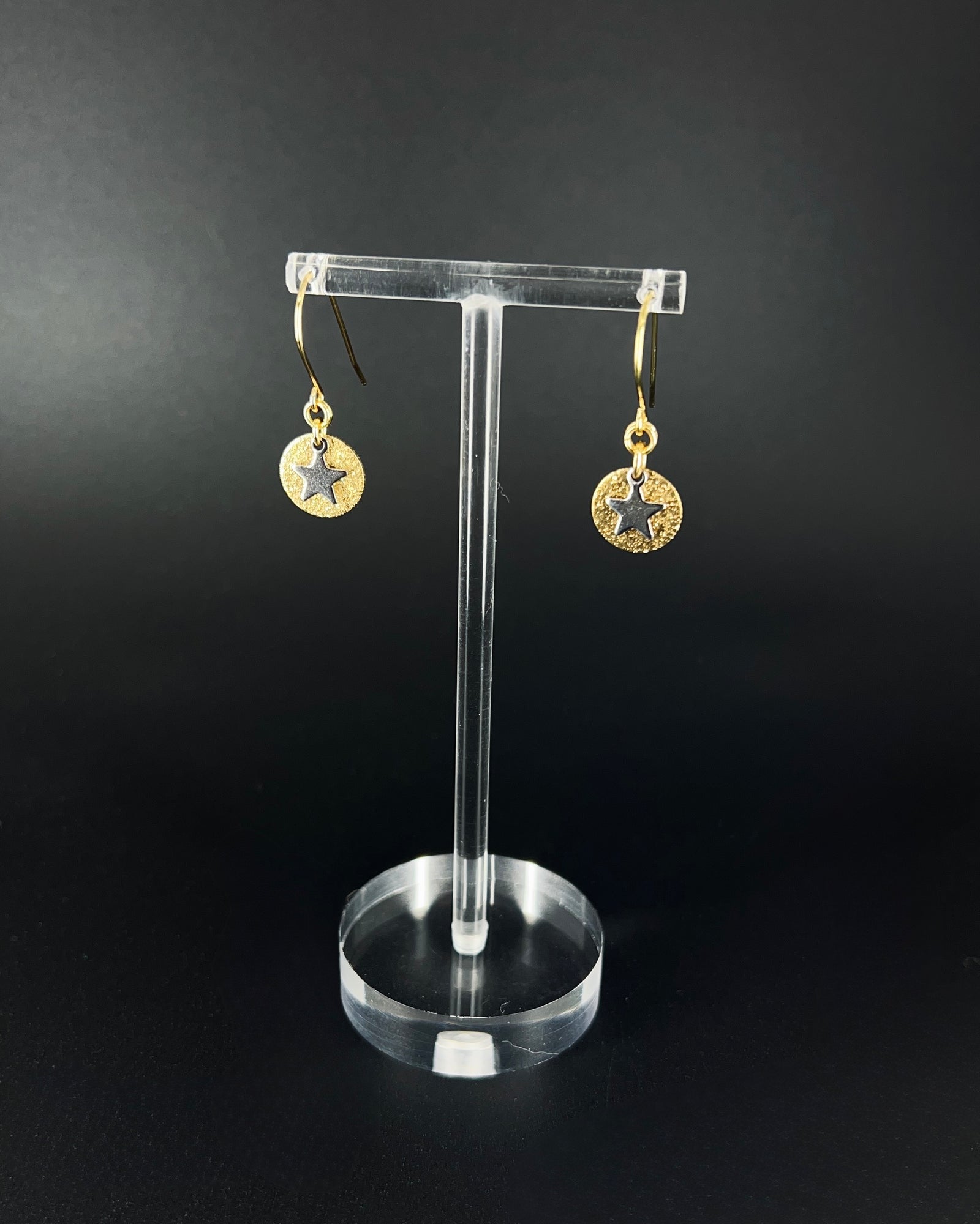 Gold and silver celestial star earrings with textured gold disc and polished silver star charm on stainless steel hooks