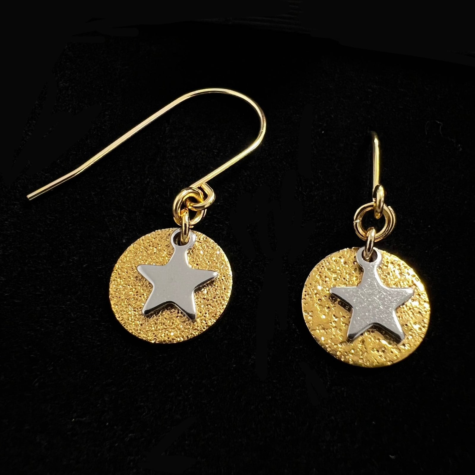 Gold and silver celestial star earrings with textured gold disc and polished silver star charm on stainless steel hooks