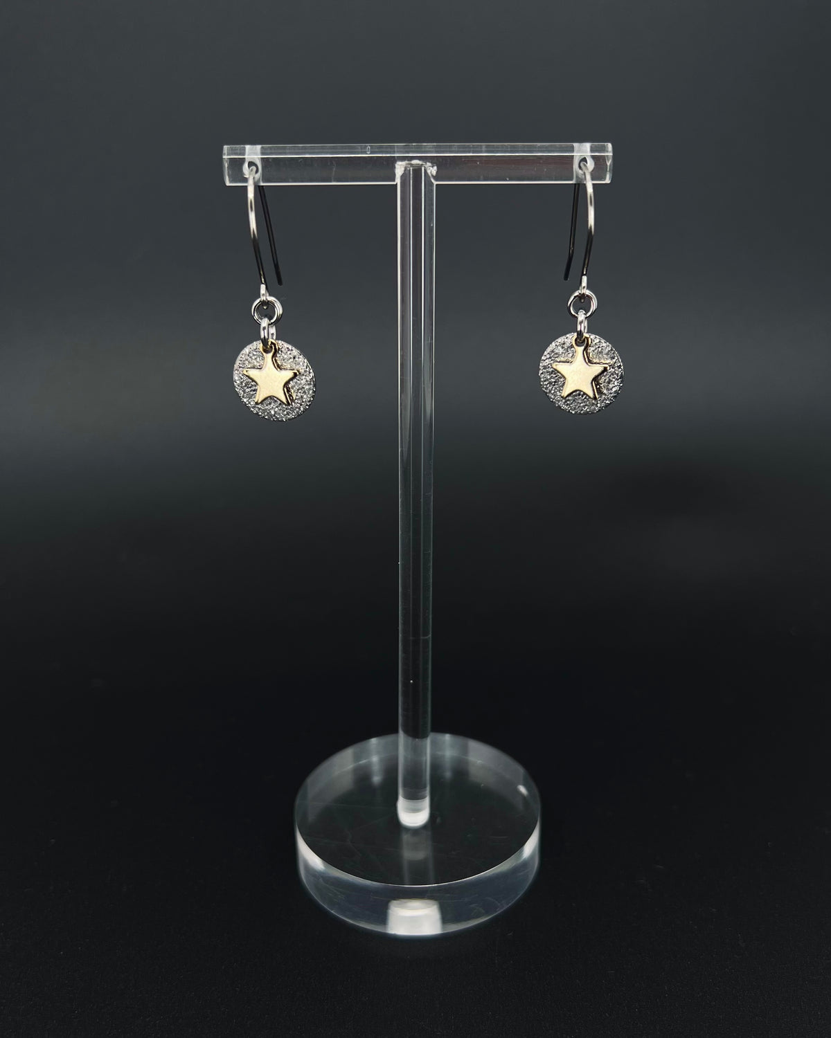 Silver and gold celestial star earrings with textured silver disc and polished gold star charm on stainless steel hooks