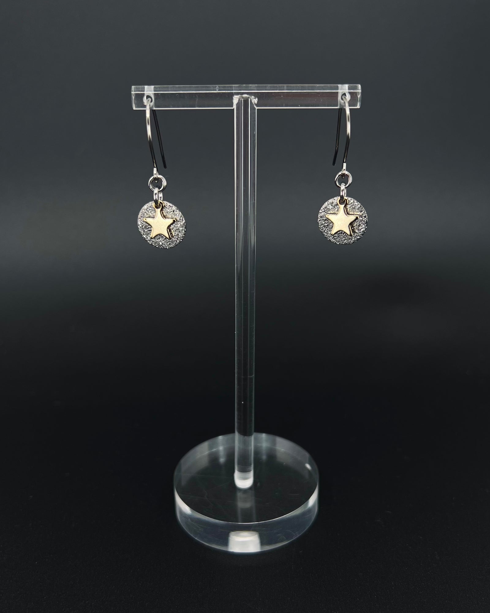 Silver and gold celestial star earrings with textured silver disc and polished gold star charm on stainless steel hooks