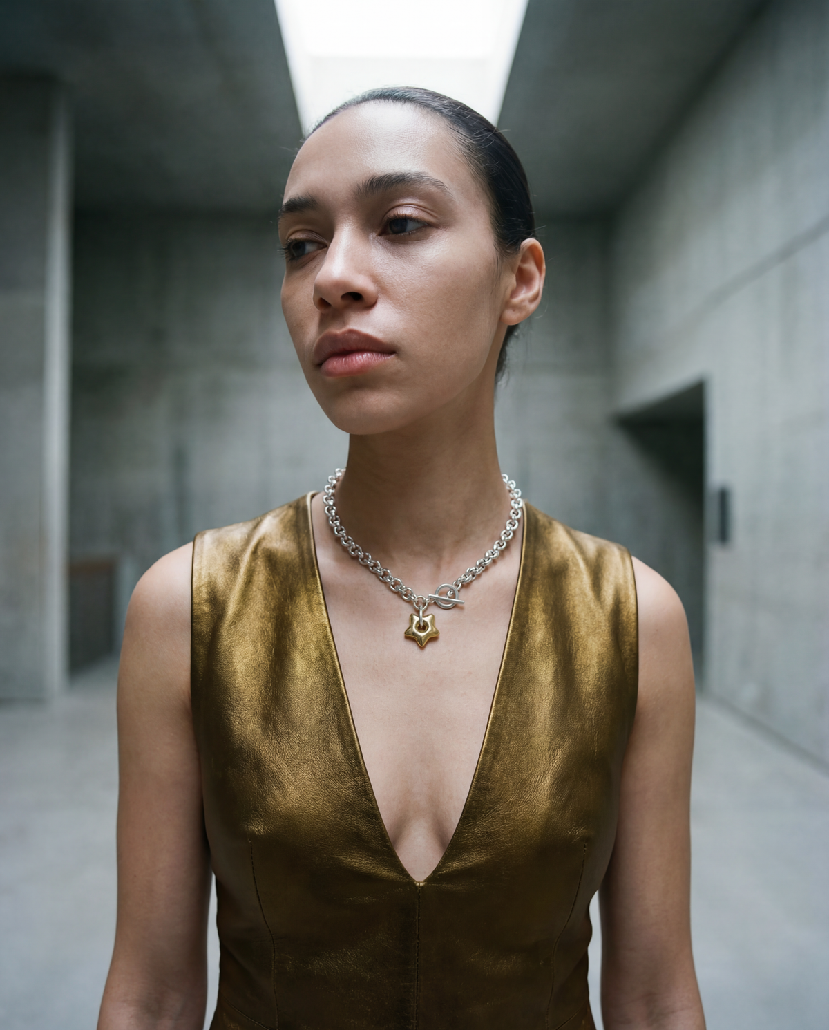 woman wearing a Silver stainless steel chain necklace with gold star pendant and toggle clasp, Urania Axis Necklace by Lawless Jewellery 