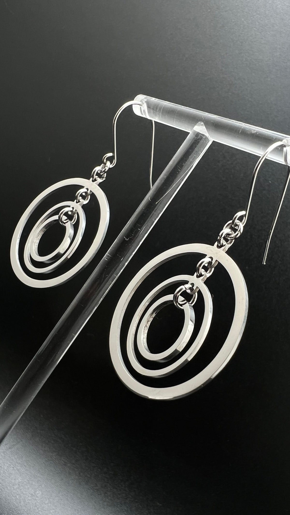 Silver stainless steel triple-ring earrings with three interlinked high-polish rings and stainless steel hooks, 5 cm length — Lawless Jewellery.