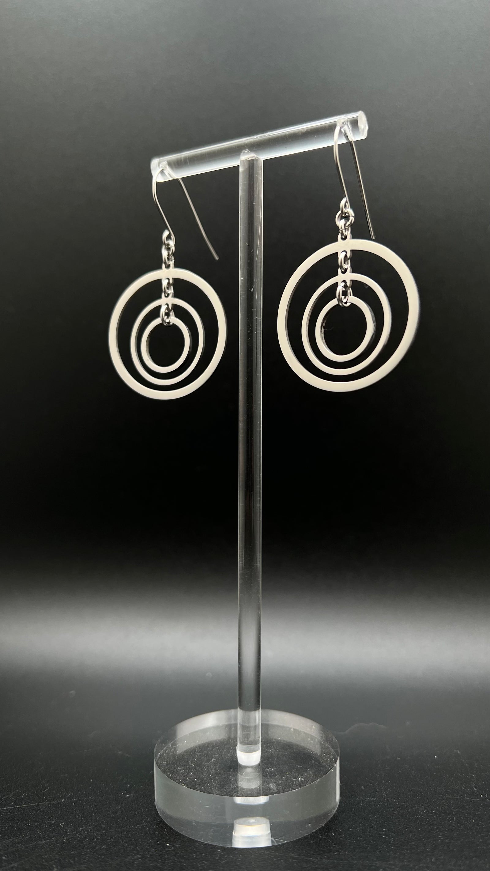ilver stainless steel triple-ring earrings with three interlinked high-polish rings and stainless steel hooks, 5 cm length — Lawless Jewellery.