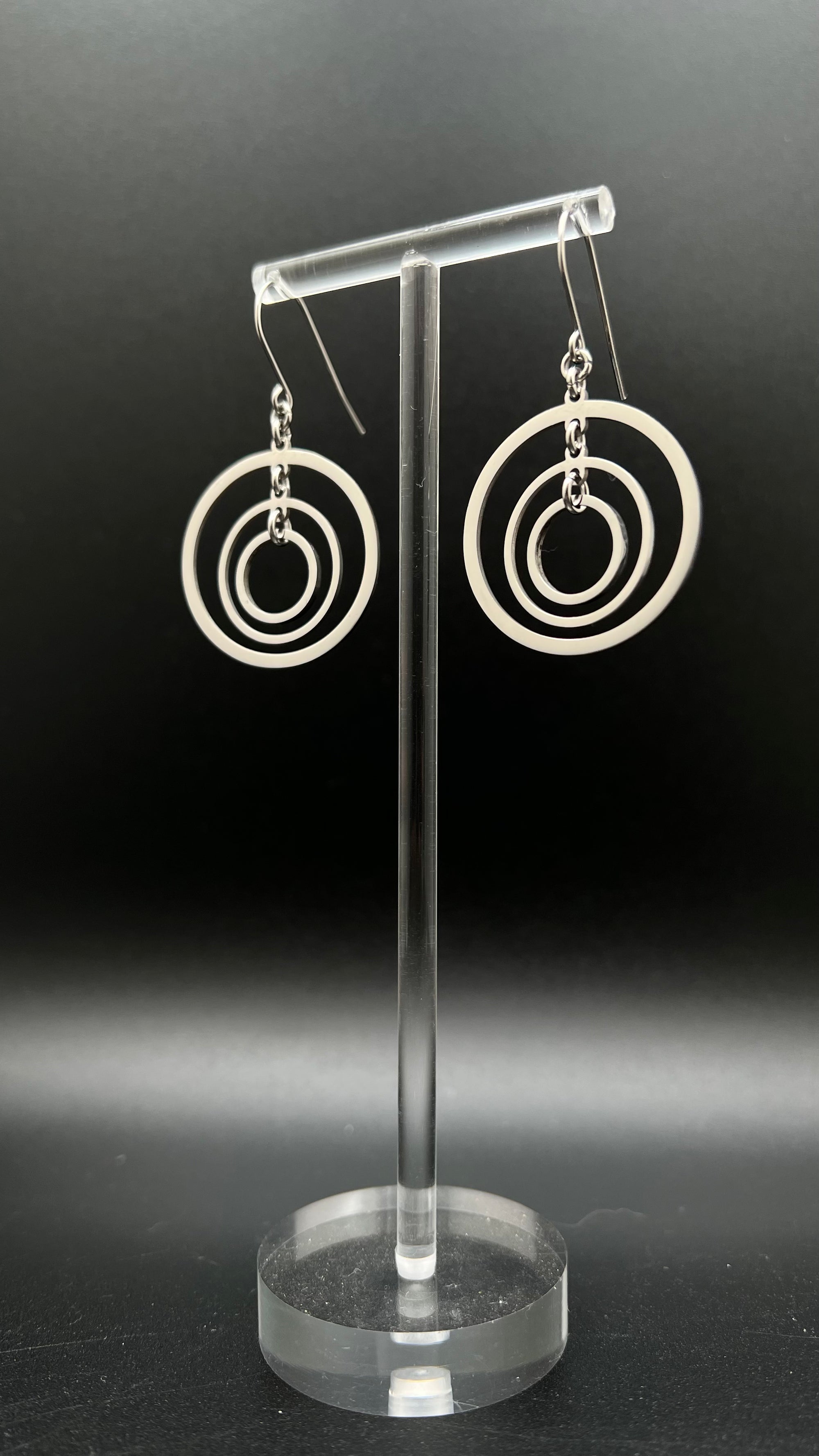 ilver stainless steel triple-ring earrings with three interlinked high-polish rings and stainless steel hooks, 5 cm length — Lawless Jewellery.