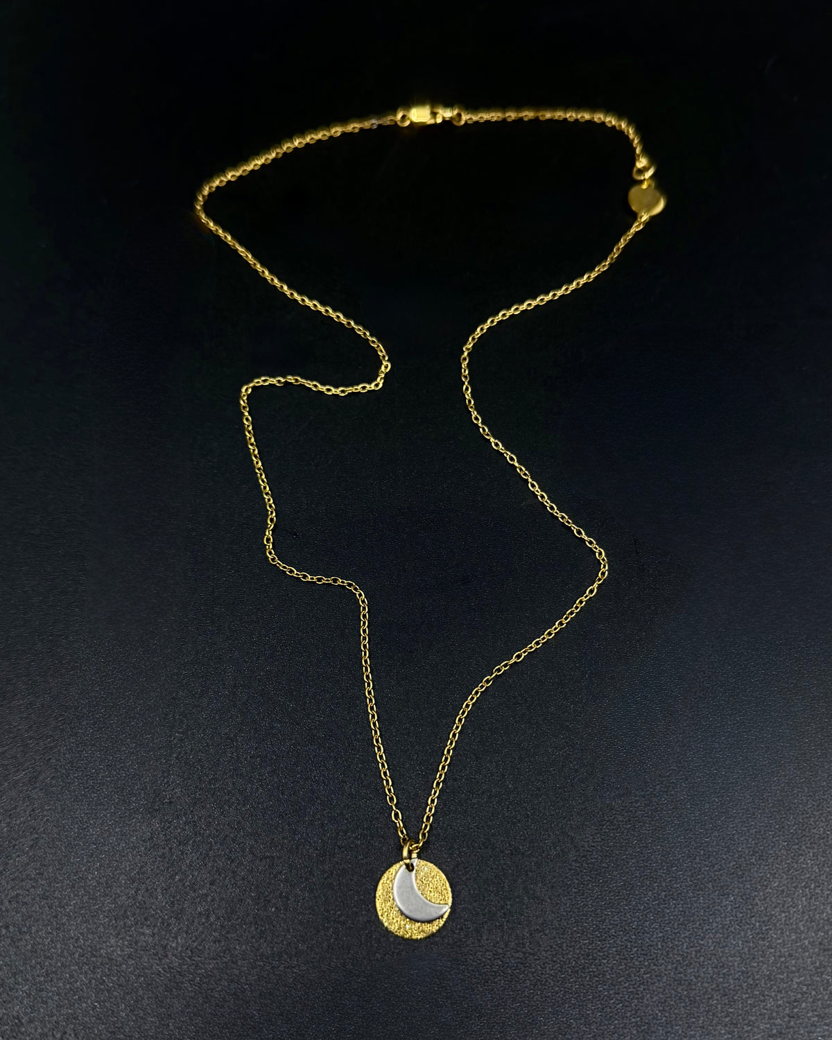 Mixed metal Urania Signal necklace with gold textured disc and silver crescent moon pendant on adjustable gold stainless steel chain