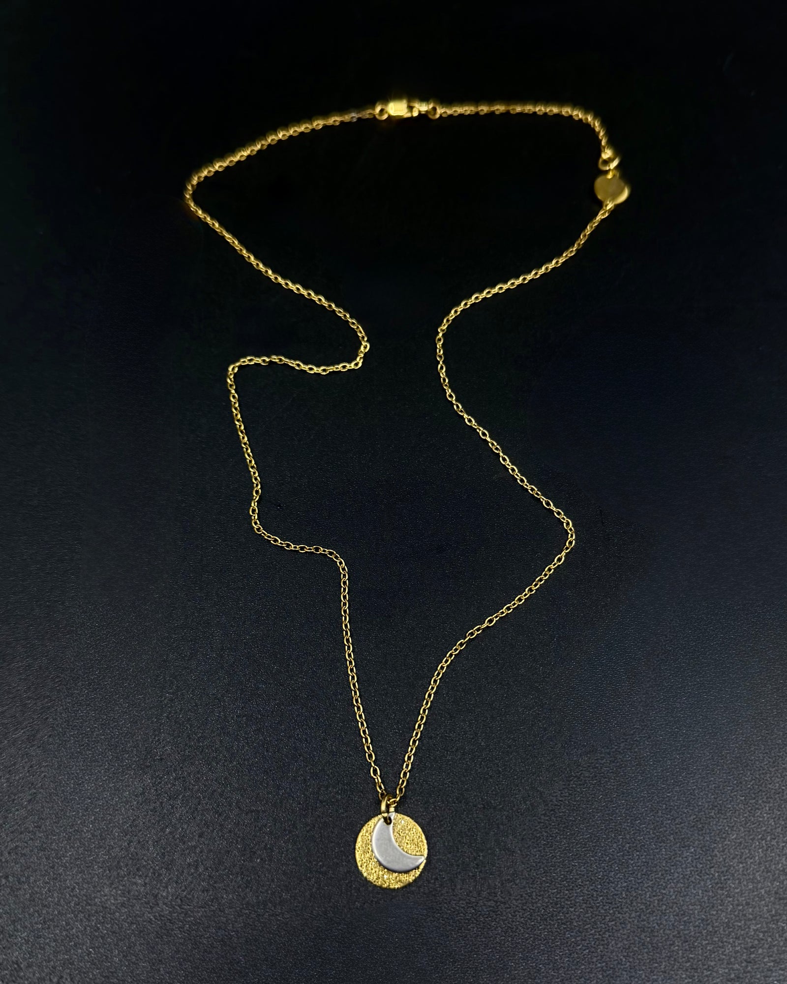 Mixed metal Urania Signal necklace with gold textured disc and silver crescent moon pendant on adjustable gold stainless steel chain