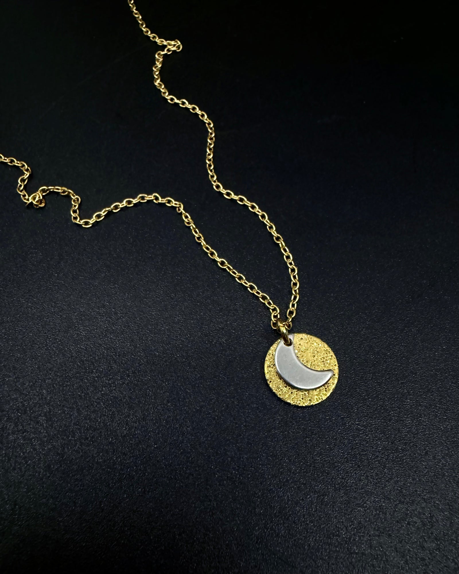 Mixed metal Urania Signal necklace with gold textured disc and silver crescent moon pendant on adjustable gold stainless steel chain
